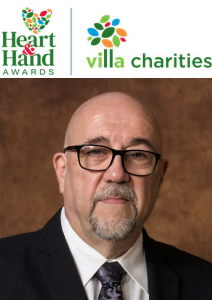 Portrait of Santo Veltri, founding partner of Bianchi Presta LLP, recognized with the 2024 Heart & Hand Award by Villa Charities, celebrating his outstanding dedication to community service.